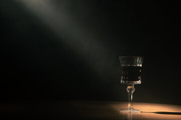 atmosphere in the night jazz bar. glass of wine on a dark background