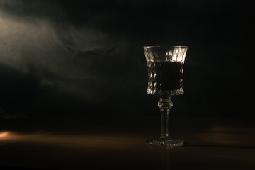 vintage glass in a smoky room with rays of light.