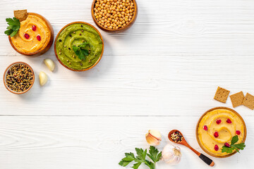 Vegetarian hummus snacks with spinach and chickpeas, flatlay