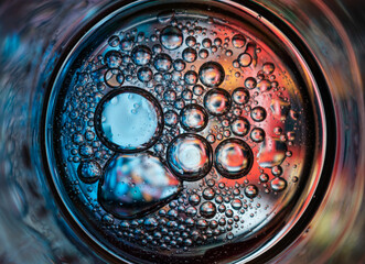 Oil bubbles in water on a colorful background