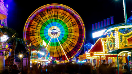 Soest, Germany - November.05.2022: Colorfully illuminated ferris wheel at a funfair at night with...