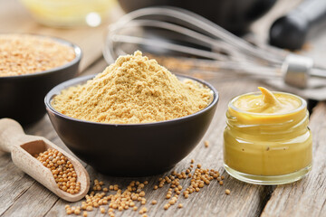 Mustard sauce jar and bowl of powdered mustard seeds. Scoop of whole mustard grain. - 501193393