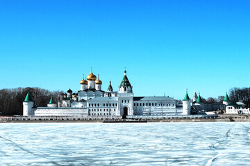 View of the monastery and churches across the river, covered with ice in winter, on a sunny day