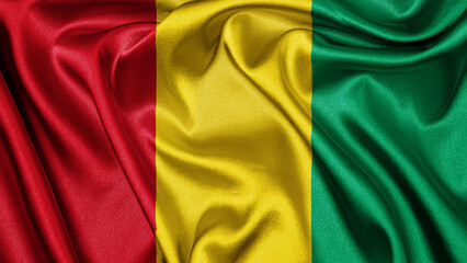 Obraz premium Close up realistic texture fabric textile silk satin flag of Guinea waving fluttering background. National symbol of the country. 2nd of October, Happy Day concept