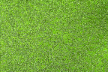 Green background with abstract pattern of various shapes, fabric and paper texture