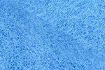 Fototapeta na wymiar Blue fiber polishing pads textured background, Texture of a abrasive scourer dishwashing sponge. Background of a scrub cleaning sponge close up. 