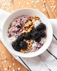 Oatmeal bowl with blackberries, hazelnut, coconut, healthy, put ina bowl, breakfast meal