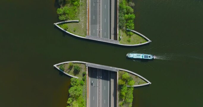 Aquaduct Veluwemeer water bridge with Two boats crossing above highway traffic, Aerial view.