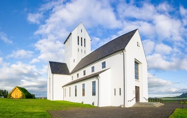 Fototapeta na wymiar Fish-eye wide angle photo of white Skalholt church in Iceland with blue sky