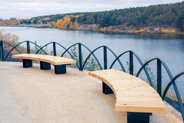 benches in the park on the banks of the river in autumn