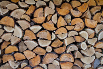 Pile of firewood of mixed colors and sizes