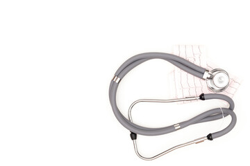 Flatlay arrangement. Stethoscope with electrocardiogram sheet isolated on white background. Place to copy paste.