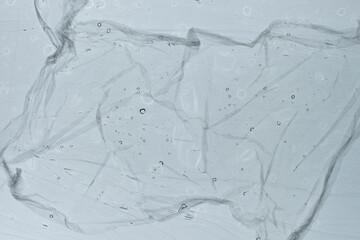 Abtract textured light bluish grey background with water drops.