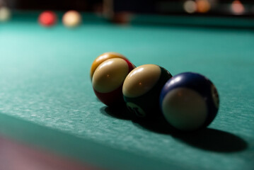 Colorful isolated balls on the pool table. Balls on a blurry green background.