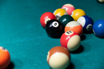 Colorful isolated balls on the pool table. Balls on a blurry green background.