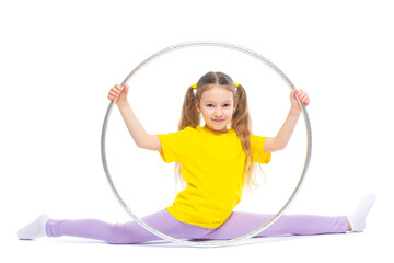 Obraz premium Little cute girl with hula hoop doing stretching. Isolated on white background.