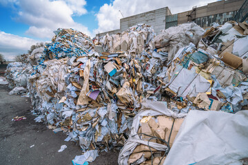 Waste paper for sorting and filing for processing at paper recycling plant. Production of new paper from garbage.