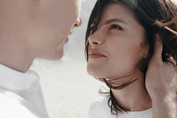 Young couple man and woman going to kiss outdoors. Calm romantic mood. Close up.