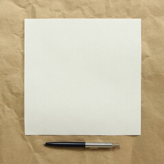 Square white empty sheet of paper with pen on a beige craft paper. Concept of analysis, study, attentive work. Stock photo with empty place for your text and design. Square image shape.