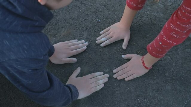 prints of child hands in chalk on the pavement. Selective focus.