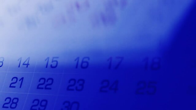 Paper calendar pages flip. Timing concept