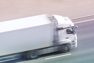 White box truck driving fast with blank space for text on a highway city road