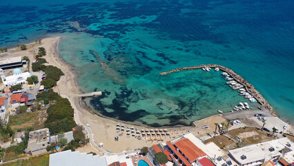 Aerial drone photo of iconic picturesque village, main port and beautiful turquoise beaches of...