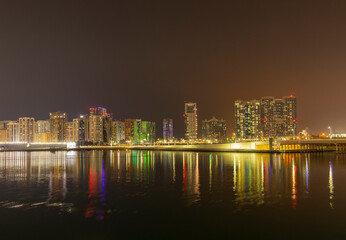 Obraz premium Night time cityscape of the Al Maryah district of Abu Dhabi, United Arab Emirates