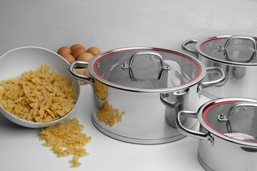 Stainless steel kitchen cookware on non isolated background