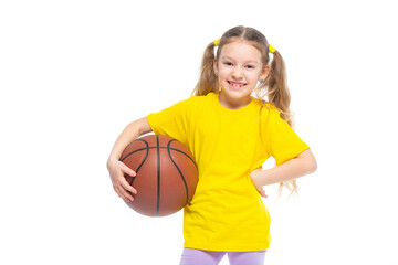 Little cute girl holding a basketball in her hand. Isolated on white background.