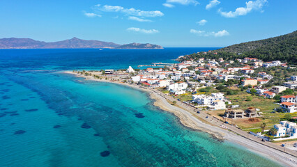 Aerial drone photo of iconic picturesque village, main port and beautiful turquoise beaches of Skala featuring landmark church of Agioi Anargiroi, Agistri island, Saronic gulf, Greece