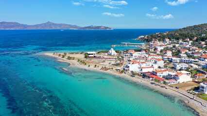 Aerial drone photo of iconic picturesque village, main port and beautiful turquoise beaches of Skala featuring landmark church of Agioi Anargiroi, Agistri island, Saronic gulf, Greece © aerial-drone