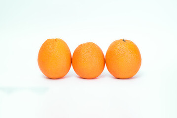 Three ripe juicy oranges isolated on white background. Healthy food.