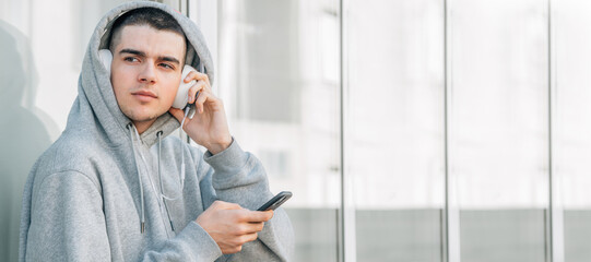teenager with mobile phone and earphones outdoors