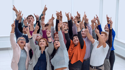 a group of older people raised their hands trying to reach