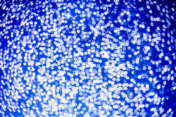 blue bokeh defocused glitter, abstract background with navy blue bokeh on a dark background