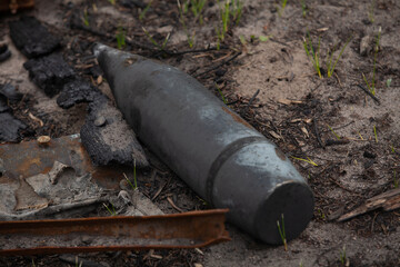 Unexploded shells lie on the ground