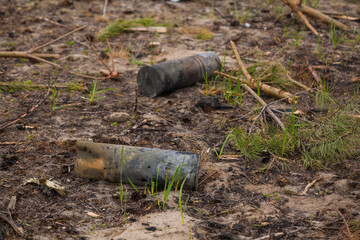 Unexploded shells lie on the ground