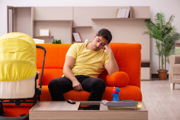 Young man looking after new born at home