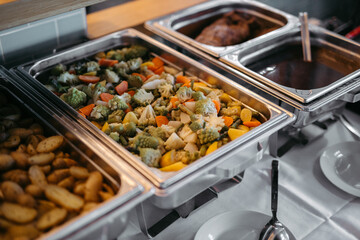 Cooked vegetables in a silver tray at a buffet