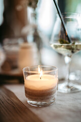 Burning candle as part of the table decoration at a wedding