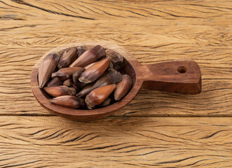 Pine tree seed, typical brazilian june festival food over wooden table