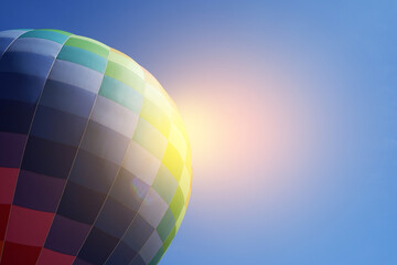 Colorful hot air balloon in flight against the blue sky.