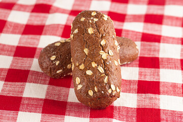 Dark Brown Bread with Oats on a Red and White Table Cloth