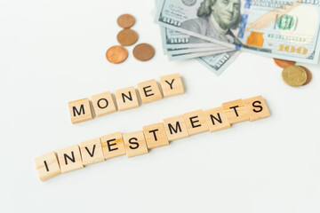 International currency money including euro, dollar, coin, dollar bill. The inscription in wooden letters money investments. The concept of investments, loans, debts.