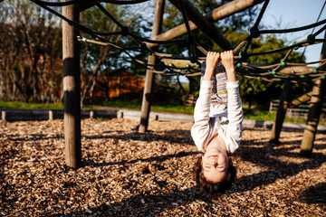 Positive cute child playing at the field, happy and excited kid. Candid photography