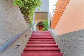 Staircase with red steps and wall-mounted metal railing at San Francisco, California