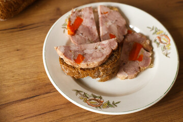 Homemade ham on a beautiful vintage plate. Cooking meat dishes at home. Beautiful food presentation. The concept of healthy proper nutrition.
