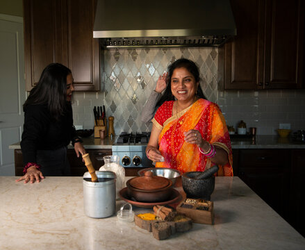 Mother and daughters in the kitchen - having fun 