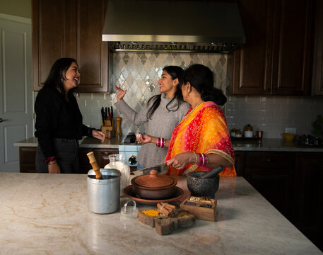 Mother and daughters in the kitchen - having fun 